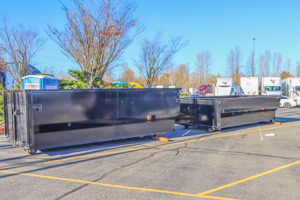 Professional dumpster rental service with roll-off container on residential driveway in Savoy